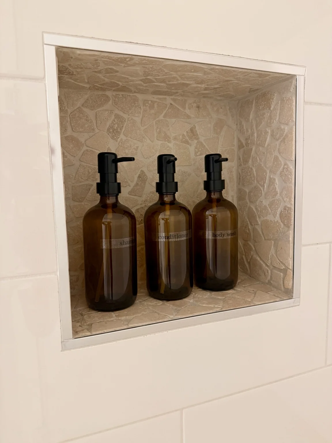 Bathroom essentials in shower niche